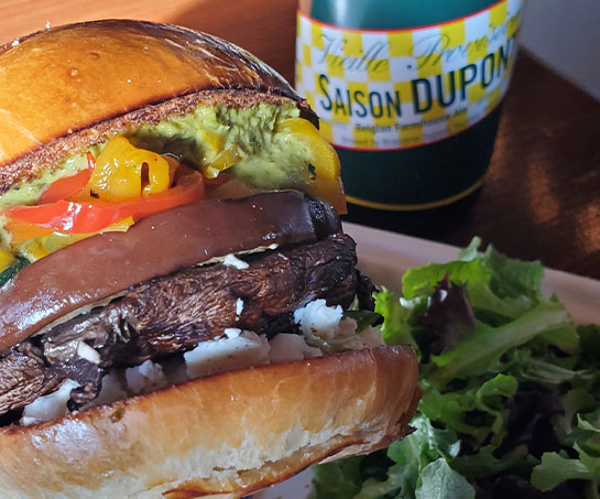Mushroom burger next to Saison Dupont bottle